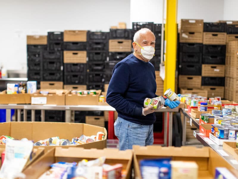 Volunteer sorts cans at Harvey Kornblum food pantry
